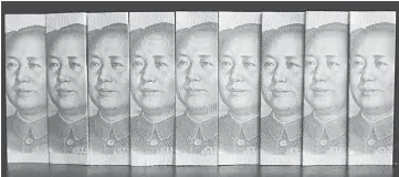  ??  ?? Chinese 100 yuan banknotes are seen in this picture illustrati­on taken in Beijing in this file photo. China looks set to allow more bond defaults as part of its market reform agenda, but domestic ratings agencies and bond investors are still betting...