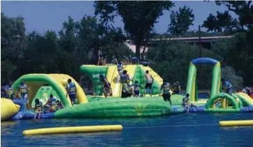  ??  ?? LEFT: The inflatable Wibit structure in Santa Rosa’s Park Lake has been a big draw, and more attraction­s are being added this summer.