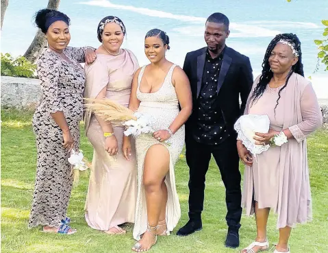  ?? ?? The bride is supported on the happiest day of her life by her close family members and friends. From left: Simone Lawrence, Ishicka Phillips , the bride in her reception dress, Ewart Lawrence and Blossom Bent.