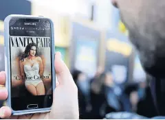  ?? AFP ?? A man views the July cover of ‘Vanity Fair’ featuring Caitlyn Jenner.