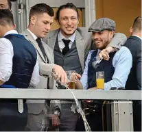 ?? MARK LARGE ?? Disgraced: James Collins (left) pours liquid over the balcony in 2016 at Cheltenham while fellow players Luke Ayling (centre) and Samir Carruthers look on