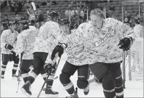  ?? Reed Saxon/Associated Press ?? The Anaheim Ducks practiced in camouflage jerseys to honor U.S. armed forces at Military Appreciati­on Night Sunday before their home game against the Vancouver Canucks.