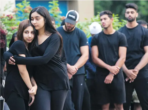  ?? GERRY KAHRMANN/PNG ?? Family and friends remember Kiran Dhesi during a candleligh­t vigil at Surrey’s Cougar Creek Elementary School.