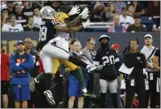  ??  ?? The Raiders’ Marcell Ateman (88) and Packers’ Chandon Sullivan battle for a pass during Thursday’s game.