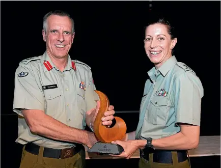  ??  ?? Lieutenant Colonel Melanie Childs was recognised for bravery in South Sudan. She is with Defence Force chief Lieutenant-general Tim Keating.