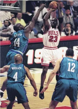  ??  ?? Hang time . . . Chicago Bulls guard Michael Jordan shoots a midrange jump shot against the Charlotte Hornets as Anthony Mason contests and David Wesley and Vlade Divac watch on at the United Centre, Chicago, in 1998.