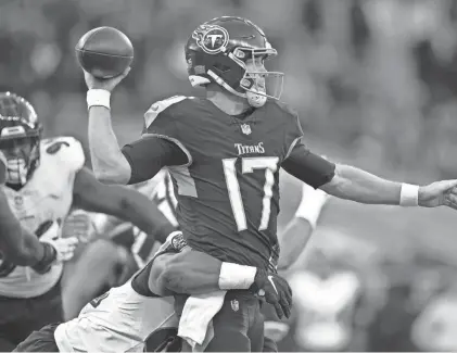  ?? ?? Titans quarterbac­k Ryan Tannehill looks to throw as he is pressured by a Ravens’ defender during the second half on Sunday at the Tottenham Hotspur stadium in London.