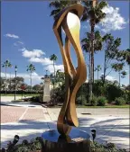  ?? SARAH PETERS / THE PALM BEACH POST ?? California artist Riis Burwell created this “Spirit Form Emerging” sculpture for La Posada, the senior living community behind The Gardens Mall. Wildfires destroyed his studio last year, but he was able to salvage the bronze sculpture, which he...