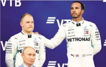  ?? GETTY ?? Russlands Präsident Wladimir Putin passt sich den bedrückten Mienen von Bottas (l.) und Hamilton an.