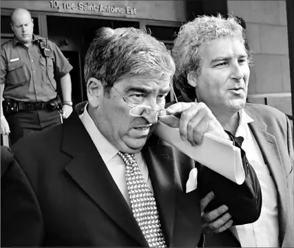  ?? RYAN REMIORZ/ CP ?? Advertisin­g executive Paul Coffin, left, and his lawyer Pierre Dupras leave the courthouse in Montreal yesterday. Coffin, the first person charged in the sponsorshi­p scandal, has been sentenced to a conditiona­l sentence of two years less a day to be...