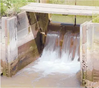  ?? DEAN HANSON/JOURNAL ?? Water flows through a Middle Rio Grande Conservanc­y District ditch gate in the North Valley. Irrigation ditches, which generally contain water from March 1 to Oct. 31, can be deadly.