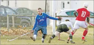  ?? Photograph: Donald Cameron. ?? Kinlochshi­el’s John MacRae, number 10, slots the ball past Lovat keeper Stuart MacDonald to score the only goal of the game at Balgate.