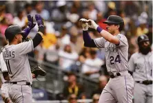  ?? Gregory Bull / Associated Press ?? Colorado’s Ryan McMahon (right) celebrates with Jose Iglesias after hitting a three-run homer against San Diego.