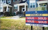  ?? ?? An advertisin­g sign for building land stands in front of a new home constructi­on site in Northbrook, Illinois, Wednesday, June 23, 2021. (AP)