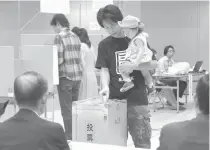  ??  ?? People cast their votes at a polling station in Tokyo on July 31. COLOGNE, Germany: LA PAZ: