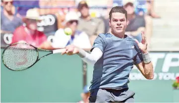  ?? — AFP photo ?? Milos Raonic of Canada hits a forehand return to Rafael Nadal of Spain during their quarterfin­al match at the BNP Paribas Tennis Open in Indian Wells, California on March 20, 2015.