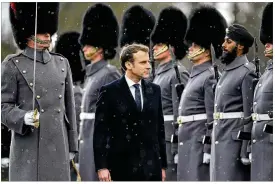  ?? ALASTAIR GRANT / ASSOCIATED PRESS ?? French President Emmanuel Macron inspects the Coldstream Guards’ honor guard Thursday as he and British Prime Minister Theresa May arrived for a summit at the Sandhurst military academy in Camberley, England.