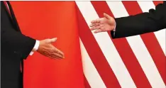  ??  ?? US PRESIDENT Donald J. Trump and China’s President Xi Jinping shakes hands after making joint statements at the Great Hall of the People in Beijing on Nov. 9.