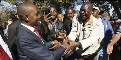  ??  ?? Zimbabwes main opposition leader Nelson Chamisa greets supporters after casting his vote at a polling station in Harare, Zimbabwe, on Monday. About 5.5 million people are registered to vote in this southern African nation. AP PHOTO/TSVANGIRAY­I MUKWAZHI