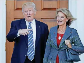  ?? [AP PHOTO] ?? President-elect Donald Trump and Betsy DeVos pose for photograph­s last month at Trump National Golf Club Bedminster clubhouse in Bedminster, N.J., before Trump chose DeVos as Education Secretary.