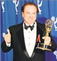  ?? Kim Kulish / AFP/ Getty Images ?? In this 1996 photo, actor Rip Torn holds his Emmy Award for Outstandin­g Supporting Actor in a Comedy Series for his role as Arthur on the “The Larry Sanders Show.”