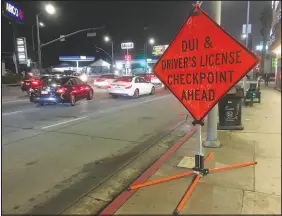  ?? SHUTTERSTO­CK.COM ?? A sign informs drivers about a DUI checkpoint on Sunset Boulevard in Los Angeles. This year, legislatio­n have been introduced in at least a dozen states that would require convicted drunken drivers to pay child support for children who lose one or both parents in a fatal accident.