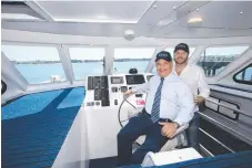  ??  ?? Mayor Tom Tate and the Hopo ferry service's general manger Anthony Arden at the helm on the Broadwater.