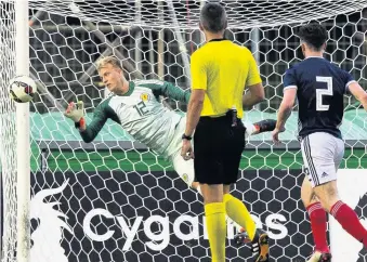  ??  ?? POWER AND McCRORIE Scotland goalie Robby makes a fine save in second half to keep his side ahead