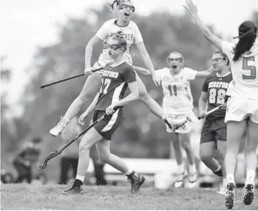  ?? BRIAN KRISTA/BALTIMORE SUN MEDIA GROUP ?? Dulaney's Kaitlyn Dabkowski leaps behind a dejected Isabella Peterson of Hereford while celebratin­g her game-winning goal in the Baltimore County championsh­ip. It was Dabkowski’s fifth goal of the game.