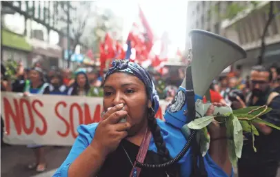  ?? PHOTOS BY LUIS HIDALGO, AP ?? A Mapuche indigenous woman shouts slogans Jan. 5, 2016, during a march in Santiago, Chile, to mark the anniversar­y of the death of Mapuche activist Matias Catrileo in 2008.