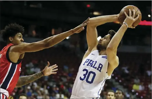  ??  ?? Philadelph­ia 76ers’ Furkan Korkmaz shoots over Washington Wizards’ Devin Robinson during the first half of an NBA Summer League basketball game Monday in Las Vegas. AP PHOTO/JOHN LOCHER