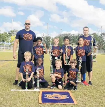  ?? EMMETT HALL/CORRESPOND­ENT ?? The undefeated Tigers took the title in 8-under play. From left, front: Brandon Nicole, Chance Fletcher, Brady Clark, Mathis Rothchild; back: Coach Jean Nicole, Logan Rigaud, Ronan Nieland, Isaias Hernandez, Michael Stringer, Head Coach Wayne Clark.