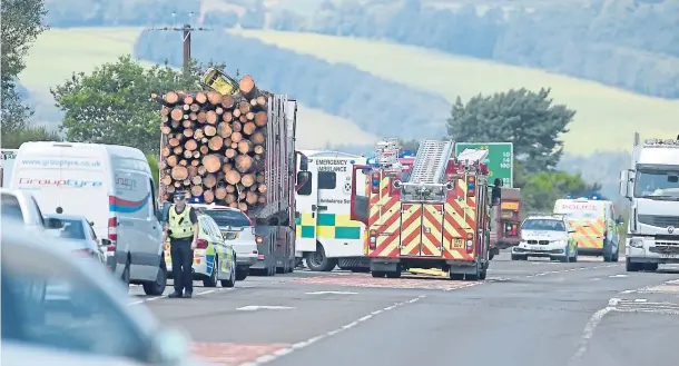  ?? Photograph­s by Sandy McCook ?? CRASH SCENE: Emergency services at the scene of an accident between a motorbike and a camper van on the A9 Inverness to Thurso road.