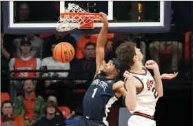  ?? THE ASSOCIATED PRESS ?? Penn State’s Seth Lundy dunks against Illinois ‘s Matthew Mayer during the first half of the Nittany Lions’ win over the Illini Saturday.