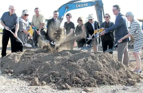  ?? LAURA BARTON/WELLAND TRIBUNE ?? Dirt flies at the sod turning event on the lands at 50 Wellspring Way in Pelham, where Wellspring Niagara will call home when it reopens next year. At the event, it was announced Wellspring Niagara, which helps families cope with cancer, is halfway to...