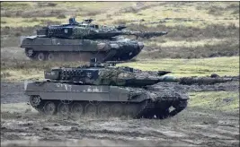  ?? MARTIN MEISSNER — THE ASSOCIATED PRESS FILE ?? Two Leopard 2tanks are seen in action at the Bundeswehr tank battalion 203at the Field Marshal Rommel Barracks in Augustdorf, Germany, on Feb. 1. Russia claimed it had “annihilate­d” eight tanks that NATO countries provided to Ukraine.