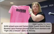  ?? Caleb Lunetta/The Signal ?? SUSD school nurse and Castaic Union School District Board Member Laura Pearson presents SUSD board members with “Fight Like a Unicorn” shirts on Tuesday.