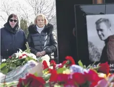  ?? ?? Lyudmila Navalnaya, left, visiting her son’s grave at the Borisovo cemetery in Moscow