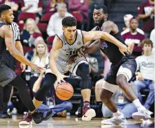  ?? AP Photo/Michael Wyke, File ?? Texas A&M center Tyler Davis (34) tries to drive between Buffalo guard C.J. Massinburg (5) and forward Ikenna Smart (34) during the second half Dec. 21 in College Station, Texas. Improved balance has created the possibilit­y of a more unpredicta­ble race...