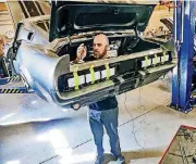  ??  ?? Anthony Matos works on a car at Classic Recreation­s in Yukon.