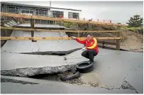  ?? ROSS GIBLIN/STUFF ?? Matt Warren looks at the damaged concrete boat launching ramp at Paeka¯ka¯riki Surf Life Saving Club.