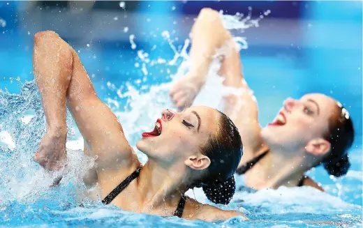  ??  ?? Chemical conspiracy: Members of the Russian synchronis­ed swimming team go through their routine at the weekend