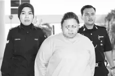  ?? - Bernama photo ?? The woman being further remanded by the Selayang Magistrate’s Court in connection with the death of a five-month-old baby.