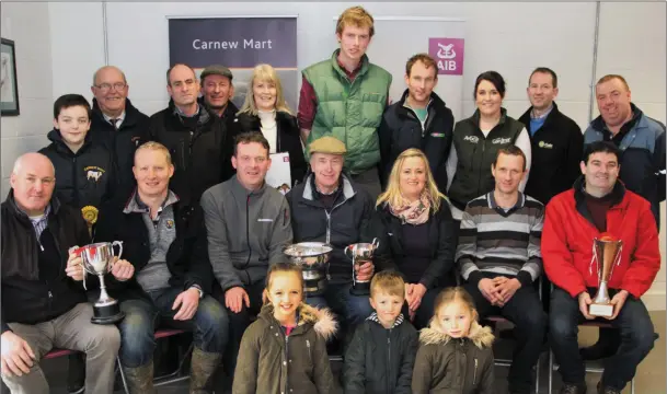  ??  ?? At the Carnew Mart 37th annual fatstock show and sale were, front row: Roisin, Ciaran and Clodagh Doyle. Sitting: Denis Keogh, Keogh Brothers, present the winning cup to Pat Nolan, best 2 or more cont. factory type bullocks; Alan Mooney, Ensor O’Connor...