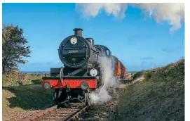  ?? ?? With the North Sea in the background, Somerset & Dorset Joint Railway 7F 2-8-0 No. 53809 heads towards Weybourne on a surviving stretch of another of England’s famous coast-serving joint lines, the Midland & Great Northern.