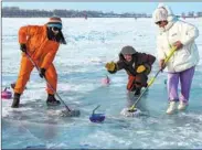  ?? SUN CHANGSHAN / FOR CHINA DAILY ?? People play curling on Feb 19 on a lake in Mishan, Heilongjia­ng province, using mops and curling stones made of ice to celebrate China’s achievemen­ts at the Beijing Winter Olympic Games, which ended on Feb 20.