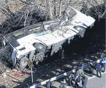  ?? EPA ?? A view of the crashed bus in Karuizawa, Nagano prefecture. The bus was carrying 39 passengers and two drivers when it veered off the road, breaking through the guard rail.