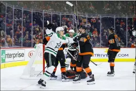  ?? CHRIS SZAGOLA — THE ASSOCIATED PRESS ?? Dallas Stars’ Roope Hintz, left, celebrates after scoring on the power play in the first period Saturday night. The Stars went on to win, 4-1.