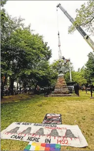  ?? Peter Hvizdak / Hearst Connecticu­t Media ?? The statue of Christophe­r Columbus was removed from Wooster Square park on Wednesday, hours after a skirmish erupted early in the morning between people of opposing viewpoints. The statue holds deep ties to the Italian- American community, as it was first erected in 1892, and later recast in bronze in 1955. Prior to the statue’s removal, protesters for and against removal demonstrat­ed, and some altercatio­ns broke out.