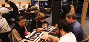  ??  ?? Iranians look at the menu at a high-end French sushi chain.